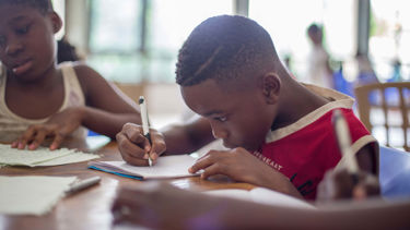 Boy working focused in class - credits Santi Vedri